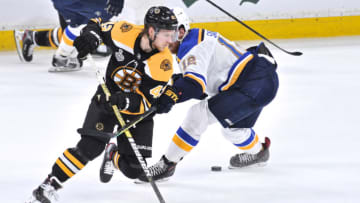 BOSTON, MA - JUNE 6: Boston Bruins center Danton Heinen (43) tries to get past St. Louis Blues left wing Zach Sanford (12) but looses the puck. During Game 5 of the Stanley Cup Finals featuring the Boston Bruins against the St. Louis Blues on June 6, 2019 at TD Garden in Boston, MA. (Photo by Michael Tureski/Icon Sportswire via Getty Images)