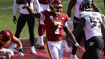 Oct 4, 2020; Landover, Maryland, USA; Washington Football Team quarterback Dwayne Haskins (7) celebrates after scoring a touchdown against the Baltimore Ravens in the fourth quarter at FedExField. Mandatory Credit: Geoff Burke-USA TODAY Sports