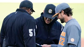 Tennessee head coach Tony Vitello (rt) inspects a bat used by right fielder Jordan Beck with umpires after Beck's home run was wiped from the scoreboard after the bat was ruled illegal during the first inning of the game against Vanderbilt at Hawkins Field Friday, April 1, 2022 in Nashville, Tenn.Nas Vandy Ut 012