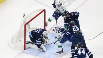 EDMONTON, ALBERTA - JULY 29: Antoine Roussel #26 of the Vancouver Canucks scores a third period goal against Connor Hellebuyck #37 of the Winnipeg Jets in an exhibition game prior to the 2020 NHL Stanley Cup Playoffs at Rogers Place on July 29, 2020 in Edmonton, Alberta. (Photo by Jeff Vinnick/Getty Images)