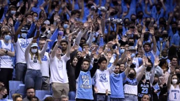 CHAPEL HILL, NORTH CAROLINA - FEBRUARY 21: North Carolina Tar Heels fans watch as their team shoots a free throw during the second half of their game against the Louisville Cardinals at the Dean E. Smith Center on February 21, 2022 in Chapel Hill, North Carolina. The Tar Heels won 70-63. (Photo by Grant Halverson/Getty Images)