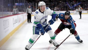 DENVER, COLORADO - FEBRUARY 27: Brock Boeser #6 of the Vancouver Canucks looks for an opening against J.T. Compher #37 of the Colorado Avalanche in the first period at the Pepsi Center on February 27, 2019 in Denver, Colorado. (Photo by Matthew Stockman/Getty Images)
