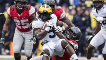 Nov 26, 2016; Columbus, OH, USA; Michigan Wolverines linebacker Jabrill Peppers (5) is tackled by Ohio State Buckeyes wide receiver Terry McLaurin (83) after an interception at Ohio Stadium. Ohio State won the game 30-27 in double overtime. Mandatory Credit: Greg Bartram-USA TODAY Sports