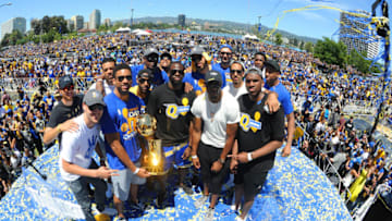 OAKLAND, CA - JUNE 15: The Golden State Warriors hold up the Larry O'Brien Trophy during the Victory Parade and Rally on June 15, 2017 in Oakland, California at The Henry J. Kaiser Convention. NOTE TO USER: User expressly acknowledges and agrees that, by downloading and or using this photograph, User is consenting to the terms and conditions of the Getty Images License Agreement. Mandatory Copyright Notice: Copyright 2017 NBAE (Photo by Noah Graham/NBAE via Getty Images)