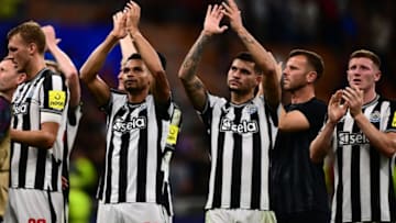 Newcastle United's English defender #33 Dan Burn, Newcastle United's English midfielder #23 Jacob Murphy, Newcastle United's Brazilian midfielder #39 Bruno Guimaraes and Newcastle United's English midfielder #32 Elliot Anderson (R) greet supporters at the end of the UEFA Champions League 1st round group F football match between AC Milan and Newcastle at the San Siro stadium in Milan on September 19, 2023. (Photo by Marco BERTORELLO / AFP) (Photo by MARCO BERTORELLO/AFP via Getty Images)