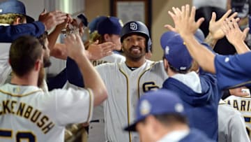 Jun 18, 2016; San Diego, CA, USA; San Diego Padres right fielder Matt Kemp (27) is congratulated after scoring during the eighth inning against the Washington Nationals at Petco Park. Mandatory Credit: Jake Roth-USA TODAY Sports