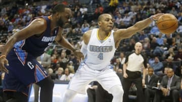 Jan 29, 2014; Denver, CO, USA; Denver Nuggets guard Randy Foye (4) recovers a loose ball in front of Charlotte Bobcats center Al Jefferson (25) during the first half at Pepsi Center. Mandatory Credit: Chris Humphreys-USA TODAY Sports