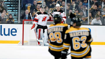 BOSTON, MA - JANUARY 23: New Jersey Devils goalie Cory Schneider (35) and New Jersey Devils center Brian Boyle (11) along with Boston Bruins right wing David Pastrnak (88) and Boston Bruins left wing Brad Marchand (63) wait as officials hash out exactly how much time is on the clock after the penalty clock was found running upwards during a game between the Boston Bruins and the New Jersey Devils on January 23, 2018, at TD Garden in Boston, Massachusetts. The Bruins defeated the Devils 3-2. (Photo by Fred Kfoury III/Icon Sportswire via Getty Images)