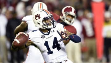 Nov 29, 2014; Tuscaloosa, AL, USA; Auburn Tigers quarterback Nick Marshall (14) throws a second quarter touchdown pass against the Alabama Crimson Tide in the second quarter at Bryant-Denny Stadium. Mandatory Credit: John David Mercer-USA TODAY Sports