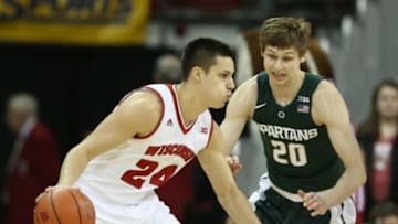 Jan 17, 2016; Madison, WI, USA; Wisconsin Badgers guard Bronson Koenig (24) moves the ball against Michigan State Spartans guard Matt McQuaid (20). Wisconsin defeated Michigan State 77-76 at the Kohl Center. Mandatory Credit: Mary Langenfeld-USA TODAY Sports