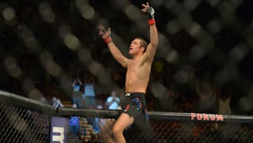 INGLEWOOD, CA - JUNE 04: Brian Ortega climbs the cage after winning his featherweight bout at UFC 199 at The Forum on June 4, 2016 in Inglewood, California. (Photo by Jayne Kamin-Oncea/Getty Images)