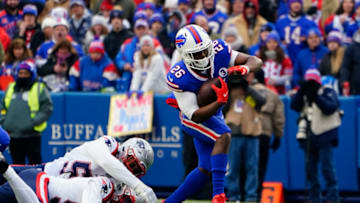 Jan 8, 2023; Orchard Park, New York, USA; Buffalo Bills running back Devin Singletary (26) runs with the ball against the New England Patriots during the first half at Highmark Stadium. Mandatory Credit: Gregory Fisher-USA TODAY Sports