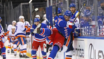 Apr 29, 2021; New York, New York, USA; Ryan Lindgren #55 of the New York Rangers is injured as he checks Cal Clutterbuck #15 of the New York Islanders into the glass during the third period at Madison Square Garden on April 29, 2021 in New York City. Mandatory Credit: Bruce Bennett/Pool Photo-USA TODAY Sports