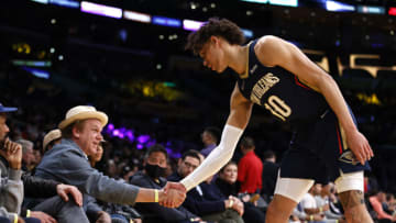 Jaxson Hayes #10 of the New Orleans Pelicans greets actor John C. Reilly (Photo by Michael Owens/Getty Images)