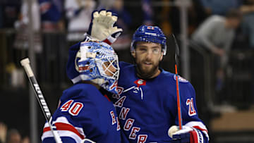 NEW YORK, NEW YORK - DECEMBER 04: Alexandar Georgiev #40 of the New York Rangers celebrates the win with teammate Barclay Goodrow #21 after the game against the Chicago Blackhawks at Madison Square Garden on December 04, 2021 in New York City. The New York Rangers defeated the Chicago Blackhawks 3-2. (Photo by Elsa/Getty Images)