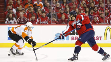 Apr 16, 2016; Washington, DC, USA; Washington Capitals defenseman John Carlson (74) shoots the puck as Philadelphia Flyers center Brayden Schenn (10) defends in the first period in game two of the first round of the 2016 Stanley Cup Playoffs at Verizon Center. Mandatory Credit: Geoff Burke-USA TODAY Sports