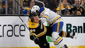 Mar 2, 2023; Boston, Massachusetts, USA; Buffalo Sabres center Peyton Krebs (19) checks Boston Bruins left wing Brad Marchand (63) during the second period at TD Garden. Mandatory Credit: Winslow Townson-USA TODAY Sports