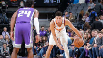 SACRAMENTO, CA - DECEMBER 29: Devin Booker #1 of the Phoenix Suns handles the ball against the Sacramento Kings on December 29, 2017 at Golden 1 Center in Sacramento, California. NOTE TO USER: User expressly acknowledges and agrees that, by downloading and or using this Photograph, user is consenting to the terms and conditions of the Getty Images License Agreement. Mandatory Copyright Notice: Copyright 2017 NBAE (Photo by Rocky Widner/NBAE via Getty Images)