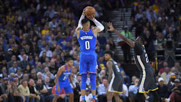 OAKLAND, CA - FEBRUARY 06: Russell Westbrook #0 of the Oklahoma City Thunder shoots over Draymond Green #23 of the Golden State Warriors during the second half of their NBA basketball game at ORACLE Arena on February 6, 2018 in Oakland, California. (Photo by Thearon W. Henderson/Getty Images)