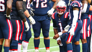 FOXBOROUGH, MASSACHUSETTS - SEPTEMBER 27: Cam Newton #1 of the New England Patriots huddles with teammates during a game against the Las Vegas Raiders at Gillette Stadium on September 27, 2020 in Foxborough, Massachusetts. (Photo by Adam Glanzman/Getty Images)