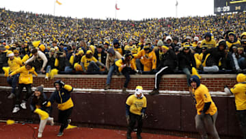 ANN ARBOR, MICHIGAN - NOVEMBER 27: Michigan Wolverines fans storm the field after the Wolverines victory over the Ohio State Buckeyes at Michigan Stadium on November 27, 2021 in Ann Arbor, Michigan. (Photo by Mike Mulholland/Getty Images)
