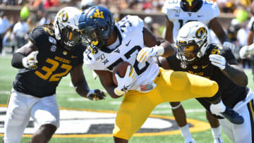COLUMBIA, MISSOURI - SEPTEMBER 07: Running back Martell Pettaway #32 of the West Virginia Mountaineers is tackled by linebacker Nick Bolton #32 and defensive lineman Akial Byers #97 of the Missouri Tigers in the third quarter at Faurot Field/Memorial Stadium on September 07, 2019 in Columbia, Missouri. (Photo by Ed Zurga/Getty Images)