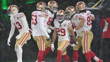 GREEN BAY, WISCONSIN - JANUARY 22: Safety Talanoa Hufanga #29 of the San Francisco 49ers is congratulated by teammates after recovering a blocked punt and running the ball in for a touchdown during the 4th quarter of the NFC Divisional Playoff game against the Green Bay Packers at Lambeau Field on January 22, 2022 in Green Bay, Wisconsin. (Photo by Quinn Harris/Getty Images)