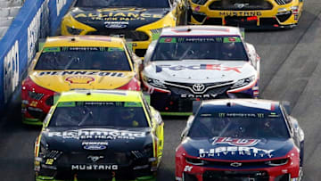 MARTINSVILLE, VIRGINIA - OCTOBER 27: William Byron, driver of the #24 Liberty University Chevrolet, races Ryan Blaney, driver of the #12 Menards/Richmond Ford, as Denny Hamlin, driver of the #11 FedEx Freight Toyota, and Joey Logano, driver of the #22 Shell Pennzoil Ford, touch during the Monster Energy NASCAR Cup Series First Data 500 at Martinsville Speedway on October 27, 2019 in Martinsville, Virginia. (Photo by Brian Lawdermilk/Getty Images)