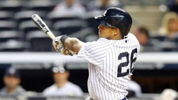 May 13, 2014; Bronx, NY, USA; New York Yankees third baseman Yangervis Solarte (26) hits a solo home run against the New York Mets during the eighth inning of a game at Yankee Stadium. The Mets defeated the Yankees 12-7. Mandatory Credit: Brad Penner-USA TODAY Sports
