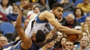Jan 23, 2016; Minneapolis, MN, USA; Minnesota Timberwolves center Karl-Anthony Towns (32) wrestles the ball away from Memphis Grizzlies guard Mario Chalmers (6) after the latter fouled the former in the fourth quarter at Target Center. The Timberwolves win 106-101. Mandatory Credit: Bruce Kluckhohn-USA TODAY Sports