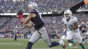 Dec 14, 2014; Foxborough, MA, USA; New England Patriots wide receiver Julian Edelman (11) catches the ball to score a touchdown in front of Miami Dolphins cornerback Brent Grimes (21) during the third quarter at Gillette Stadium. Mandatory Credit: Stew Milne-USA TODAY Sports