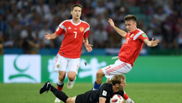 SOCHI, RUSSIA - JULY 07: Ivan Strinic of Croatia is tackled by Aleksandr Golovin of Russia during the 2018 FIFA World Cup Russia Quarter Final match between Russia and Croatia at Fisht Stadium on July 7, 2018 in Sochi, Russia. (Photo by Shaun Botterill/Getty Images)