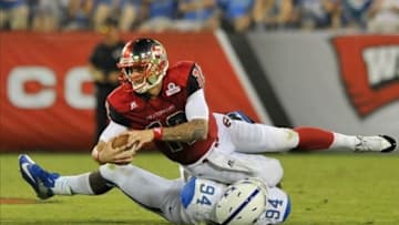 Aug 31, 2013; Nashville, TN, USA; Western Kentucky Hilltoppers quarterback Brandon Doughty (12) is sacked by Kentucky Wildcats defensive end Za