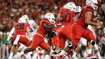 TUCSON, AZ - SEPTEMBER 01: Running back J.J. Taylor #21 of the Arizona Wildcats rushes the football during the college football game against the Brigham Young Cougars at Arizona Stadium on September 1, 2018 in Tucson, Arizona. The Cougars defeated the Wildcats 28-23. (Photo by Christian Petersen/Getty Images)
