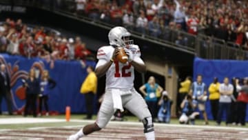 Jan 1, 2015; New Orleans, LA, USA; Ohio State Buckeyes quarterback Cardale Jones (12) throws in the pocket against the Alabama Crimson Tide during the fourth quarter in the 2015 Sugar Bowl at Mercedes-Benz Superdome. Mandatory Credit: Matthew Emmons-USA TODAY Sports