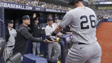 May 28, 2022; St. Petersburg, Florida, USA; New York Yankees second baseman DJ LeMahieu (26) gets congratulated by manager Aaron Boone, left, after scoring a run during the first inning against the Tampa Bay Rays at Tropicana Field. Mandatory Credit: Reinhold Matay-USA TODAY Sports