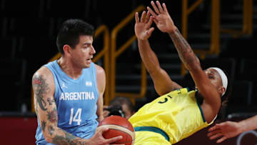 Gabriel Deck #14 of Team Argentina drives to the basket against Patty Mills #5 of Team Australia during the second half of a Men's Basketball Quarterfinal game on day eleven of the Tokyo 2020 Olympic Games at Saitama Super Arena on August 03, 2021 in Saitama, Japan. (Photo by Kevin C. Cox/Getty Images)