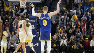 SAN FRANCISCO, CALIFORNIA - DECEMBER 28: Donte DiVincenzo #0 of the Golden State Warriors reacts after making a three-point shot against the Utah Jazz during the fourth quarter of an NBA basketball game at Chase Center on December 28, 2022 in San Francisco, California. NOTE TO USER: User expressly acknowledges and agrees that, by downloading and or using this photograph, User is consenting to the terms and conditions of the Getty Images License Agreement. (Photo by Thearon W. Henderson/Getty Images)