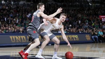 SOUTH BEND, IN - JANUARY 11: Ryan McMahon #30 of the Louisville Cardinals defends against Rex Pflueger #0 of the Notre Dame Fighting Irish in the first half of the game at Purcell Pavilion on January 11, 2020 in South Bend, Indiana. (Photo by Joe Robbins/Getty Images)