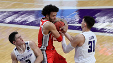 Dec 26, 2020; Evanston, Illinois, USA; Northwestern Wildcats forward Robbie Beran (31) and Ohio State Buckeyes guard Duane Washington Jr. (4) battle for the ball in the first half at Welsh-Ryan Arena. Mandatory Credit: Quinn Harris-USA TODAY Sports