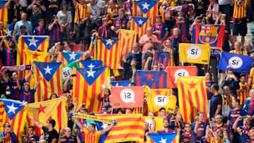Catalan football fans hold Esteladas and flag reading 'Yes' before the Spanish league football match Girona FC vs FC Barcelona at the Montilivi stadium in Girona on September 23, 2017.Spain's Prime Minister Mariano Rajoy asked Catalan separatist leaders today to own up they can't hold an outlawed independence referendum after a crackdown dealt them a serious blow this week. / AFP PHOTO / Josep LAGO (Photo credit should read JOSEP LAGO/AFP/Getty Images)