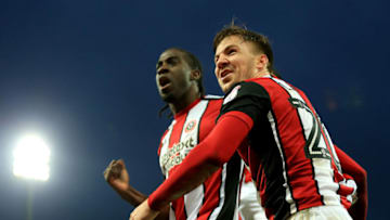 NORWICH, ENGLAND - JANUARY 20: Lee Evans and goalscorer Clayton Donaldson of Sheffield United celebrate their sides second goal during the Sky Bet Championship match between Norwich City and Sheffield United at Carrow Road on January 20, 2018 in Norwich, England. (Photo by Stephen Pond/Getty Images)