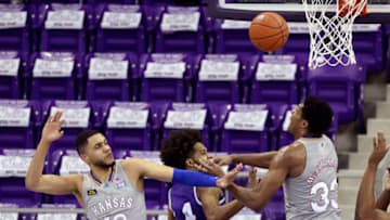 Jan 5, 2021; Fort Worth, Texas, USA; Kansas Jayhawks forward David McCormack (33) and guard Tristan Enaruna (13) battle for a loose ball with TCU Horned Frogs guard PJ Fuller (4) during the first half at Ed and Rae Schollmaier Arena. Mandatory Credit: Kevin Jairaj-USA TODAY Sports