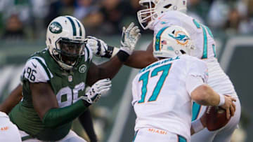 Nov 29, 2015; East Rutherford, NJ, USA; New York Jets defensive end Muhammad Wilkerson (96) chases Miami Dolphins quarterback Ryan Tannehill (17) during the second half at MetLife Stadium.The Jets defeated the Dolphins 38-20. Mandatory Credit: William Hauser-USA TODAY Sports