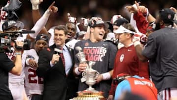 Jan 2, 2014; New Orleans, LA, USA; Oklahoma Sooners quarterback Trevor Knight (9) holds the mvp trophy as he and teammates celebrate defeated theAlabama Crimson Tide 45-3 at the Mercedes-Benz Superdome. Mandatory Credit: Crystal LoGiudice-USA TODAY Sports