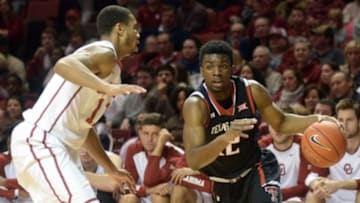 Jan 26, 2016; Norman, OK, USA; Texas Tech Red Raiders guard Keenan Evans (12) drives to the basket against Oklahoma Sooners guard Isaiah Cousins (11) during the first half at Lloyd Noble Center. Mandatory Credit: Mark D. Smith-USA TODAY Sports