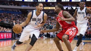 Jan 29, 2014; Dallas, TX, USA; Dallas Mavericks point guard Devin Harris (20) drives to the basket past Houston Rockets point guard Aaron Brooks (0) at the American Airlines Center. The Rockets defeated the Mavericks 117-115. Mandatory Credit: Jerome Miron-USA TODAY Sports