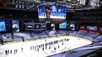 The Tampa Bay Lightning shake hands with the Boston Bruins. (Photo by Elsa/Getty Images)