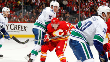 CALGARY, AB - OCTOBER 6: Austin Czarnik #27 of the Calgary Flames skates against Jake Virtanen #18 of the Vancouver Canucks during an NHL game on October 6, 2018 at the Scotiabank Saddledome in Calgary, Alberta, Canada. (Photo by Gerry Thomas/NHLI via Getty Images)"n