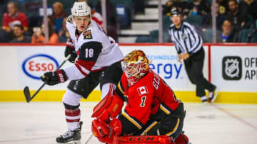 Oct 5, 2016; Calgary, Alberta, CAN; Calgary Flames goalie Brian Elliott (1) makes a save as Arizona Coyotes center Christian Dvorak (18) tries to score during the second period during a preseason hockey game at Scotiabank Saddledome. Mandatory Credit: Sergei Belski-USA TODAY Sports